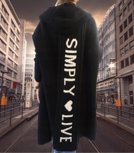 Detail of black hooded cardigan featuring white Simply Live knitted text on the back