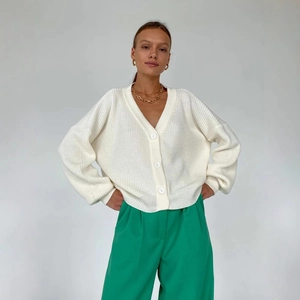 Chic white V-neck chunky knit cardigan with buttons and a relaxed fit for casual wear