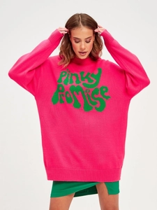 Detail of hot pink oversized knit sweater featuring green Pinky Promise graphic text