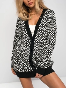 Detail of V-neck long cardigan featuring black and white geometric cube pattern texture