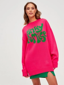 Close-up of the ribbed crewneck and green Pinky Promise lettering on pink knit sweater
