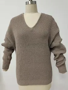 Detail of taupe chunky knit V-neck sweater with drop shoulders and ribbed cuffs on mannequin