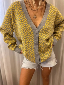 Detail of grey and yellow geometric argyle knit cardigan with large buttons