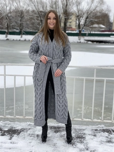 Detail of grey cable knit long cardigan with adjustable waist belt and side slits