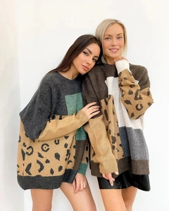 Detail of oversized knit sweater featuring bold color block and classic leopard patterns