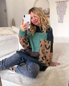 Close-up of leopard print patchwork and color block detail on knit sweater