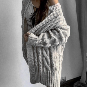 Detail of grey cable-knit texture and oversized drop-shoulder design on this cardigan