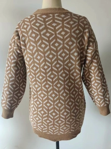 Detail of V-neck cardigan featuring brown and white geometric plaid pattern and ribbed cuffs