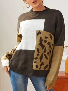 Close-up of knit sweater featuring leopard print patterns and geometric color blocking