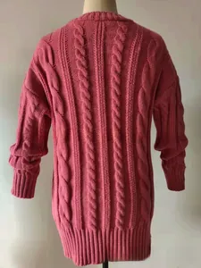 Detailed back view of a pink cable knit cardigan showing texture and ribbed hem
