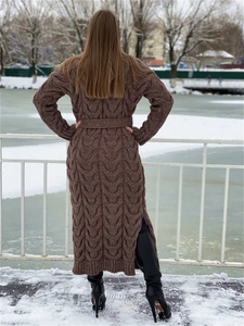 Detail of chunky knit cable texture on long brown cardigan with belt in snowy landscape