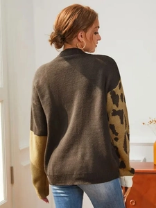 Detailed back view of knit sweater with leopard print sleeves and mustard yellow patch