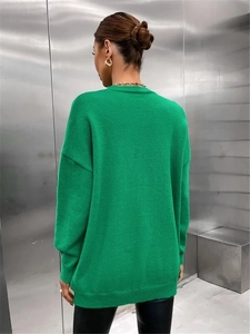 Detailed back view of oversized bright green knit sweater with drop shoulder design