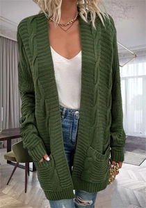 Detailed view of forest green cable knit texture and large functional pockets on cardigan