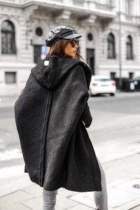 Street style shot of black hooded knit cardigan with textured bouclé wool finish