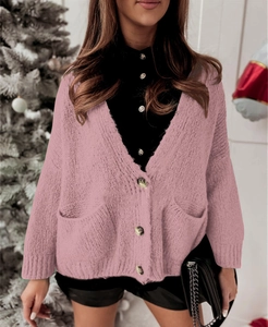 Chic pink knit cardigan with V-neck and pockets for women in a festive cozy setting