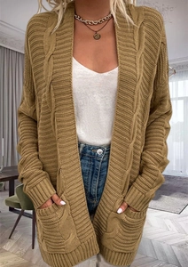 Detail shot of cable knit texture on a long mustard yellow open front cardigan