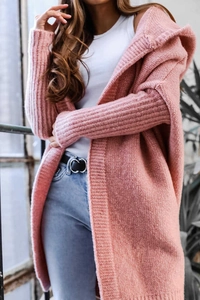 Detailed close-up of pink knit cardigan with a hood and textured chunky knit fabric