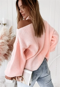 Close-up of light pink chunky knit sweater with off-shoulder design and drop shoulder detail