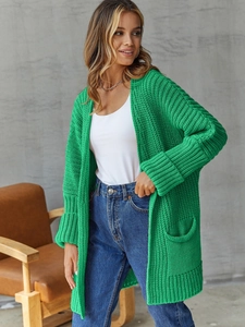 Detail of emerald green chunky knit cardigan with drop shoulders and large side pockets