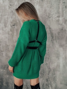 Detail of green oversized knit sweater dress with black leather harness accessory