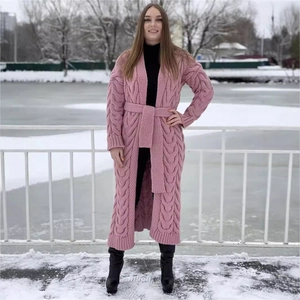 Long pink cable knit cardigan with waist belt for women in winter outdoor snow scene