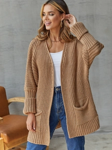 Detail of camel chunky knit cardigan showing large front pockets and ribbed cuffs