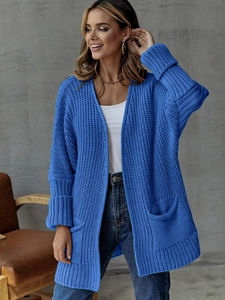 Detailed macro view of a royal blue chunky knit cardigan with large side pockets