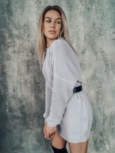 Detail of light gray chunky knit sweater dress with soft texture and waist belt