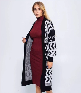Detail of long knit cardigan featuring bold black and white geometric jacquard pattern