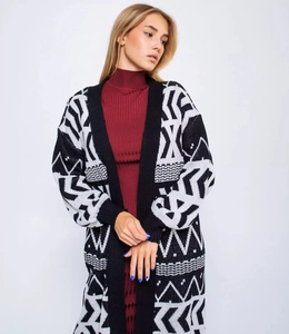 Detail of long knit cardigan with black and white geometric jacquard and wavy pattern