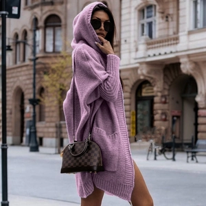 Detail of a purple chunky knit cardigan featuring a cozy hood and deep side pockets