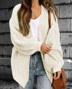 Detailed close-up of cream chunky knit cardigan featuring loose puff sleeves and texture