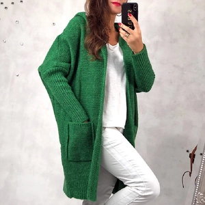 Detail of green long hooded knit cardigan featuring chunky knit texture and large pockets