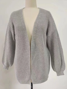 Detail of grey oversized knit cardigan with chunky texture and lantern sleeve design