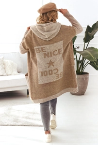 Detail of knit cardigan showing jacquard Be Nice text and star pattern on the back