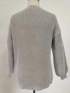 Rear view detail of chunky knit cardigan featuring drop shoulder and ribbed cuffs in light grey