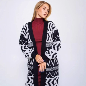 Long knit cardigan with black and white geometric pattern and red turtleneck dress
