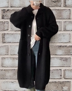 Long black knit cardigan with buttons and pockets in a relaxed casual style for autumn
