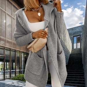 Detail view of light grey knit cardigan with large side pockets and ribbed texture