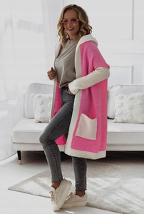 Close-up of bright pink and off-white knit cardigan with hood and large functional pocket