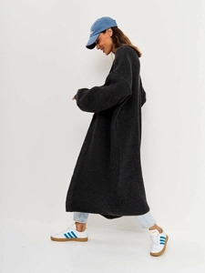 Side view of long dark grey chunky knit cardigan with relaxed dropped shoulders