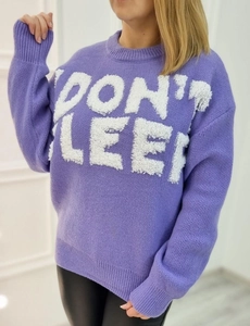 Close-up of long sleeve purple knit sweater with plush 'DON'T SLEEP' white lettering