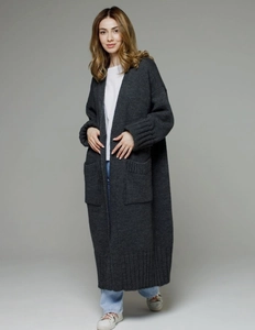 Detail showing dark grey chunky knit cardigan texture and large patch pocket design