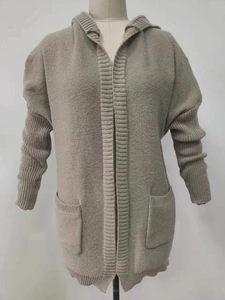Detailed close-up of taupe knit hooded cardigan featuring ribbed pockets and textured fabric