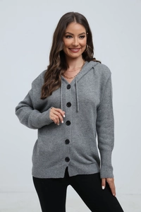 Detail of grey knitted hooded cardigan with single-breasted buttons and ribbed cuffs
