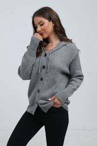 Detail view of the gray knitted hoodie cardigan with large buttons and ribbed cuffs