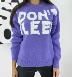 Detailed view of purple knit sweater featuring 3D white DON'T SLEEP embroidery on chest