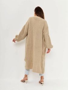 Rear view of a beige long knit cardigan showing relaxed fit and ribbed texture detail