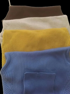 Vertical rib knit texture detail on slim fit sweaters in brown, white, yellow, and blue
